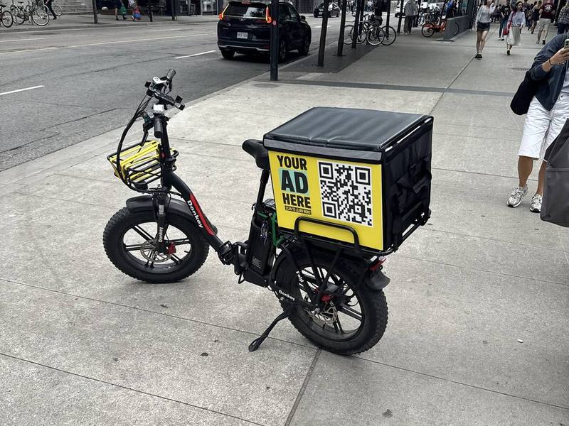 E-bike delivery bag with an advertising panel in downtown Toronto
